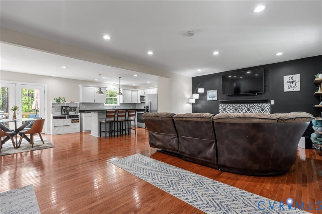 1290 Scotts Court Carson, VA 23830 - Photo 5 of 46 a living room with furniture a flat screen tv and kitchen view