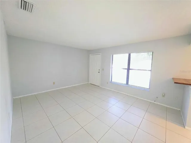 a view of kitchen with refrigerator and window