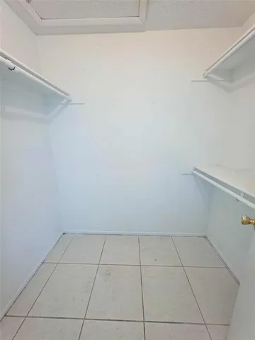 a bathroom with a bathtub shower sink vanity mirror and toilet