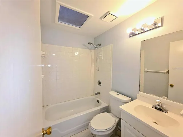 a view of a backyard with potted plants and large tree