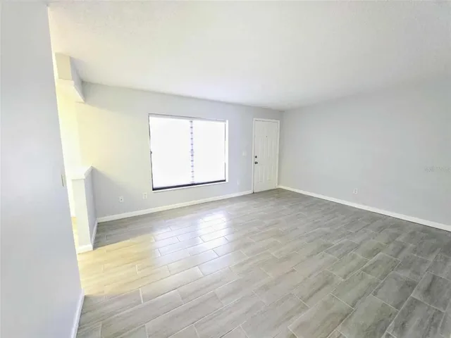 an empty room with wooden floor