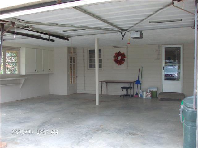 705 Baker Road Smyrna, TN 37167 - Photo 6 of 20 LARGE 2 car garage with 2 overhead doors, one with opener. Tons of storage cabinets. Need more living space, convert this area.