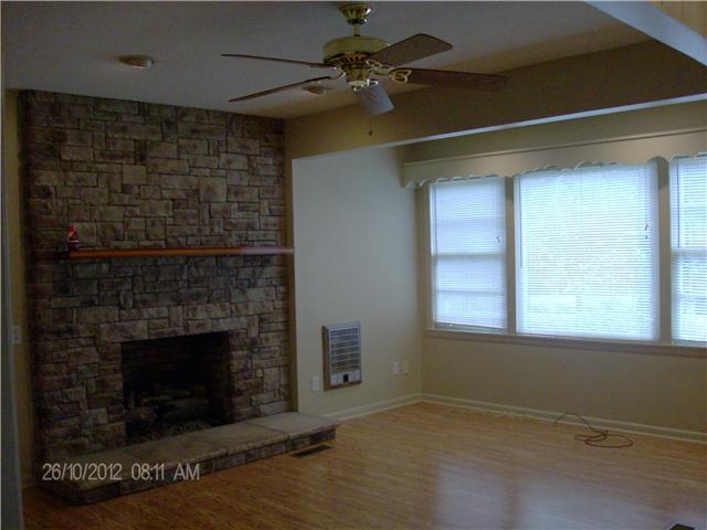 705 Baker Road Smyrna, TN 37167 - Photo 9 of 20 Living room open from eat-in kitchen has stone fireplace, large picture window and recessed lighting.