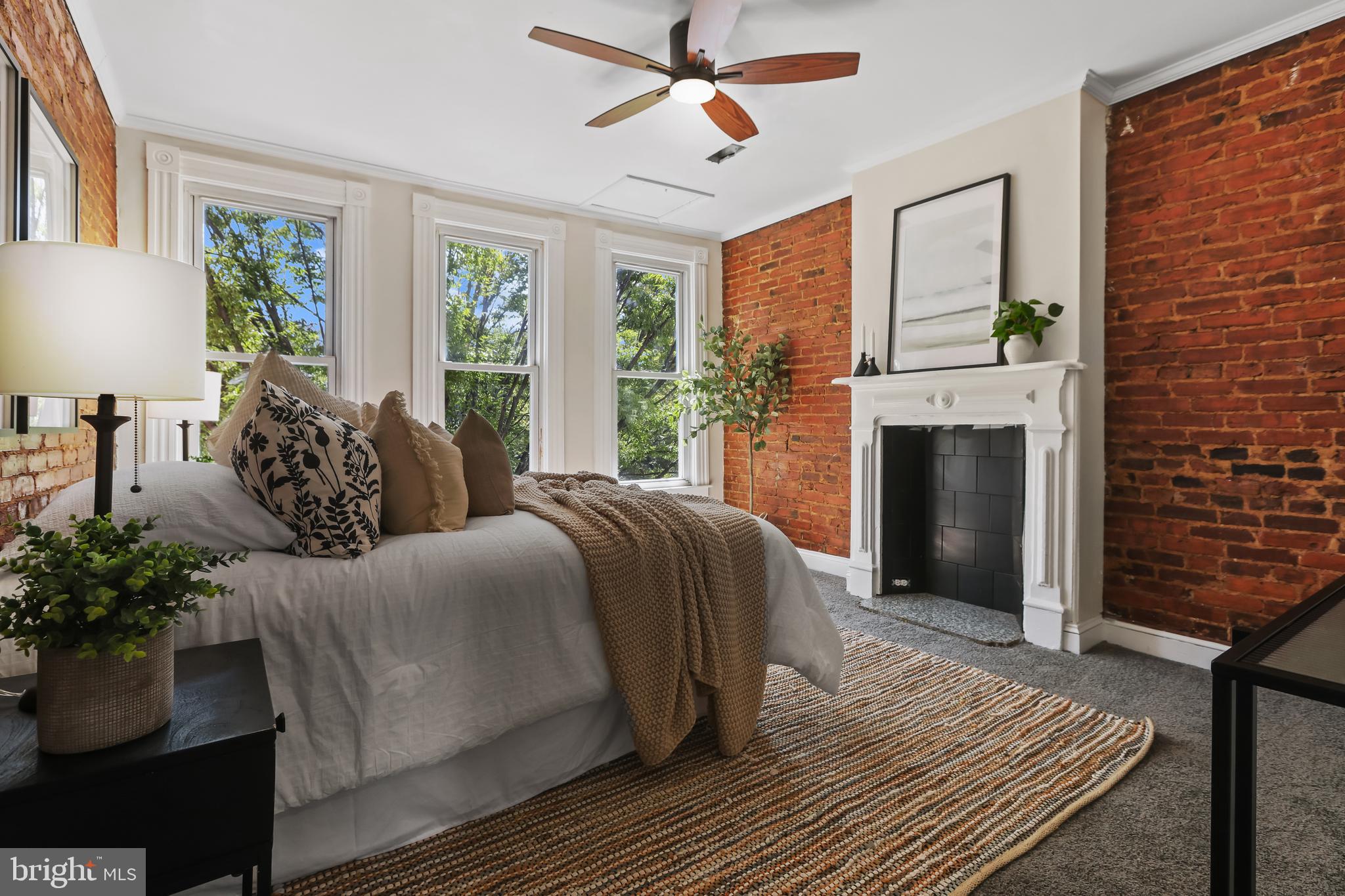 a spacious bedroom with a balcony a bed and a fireplace