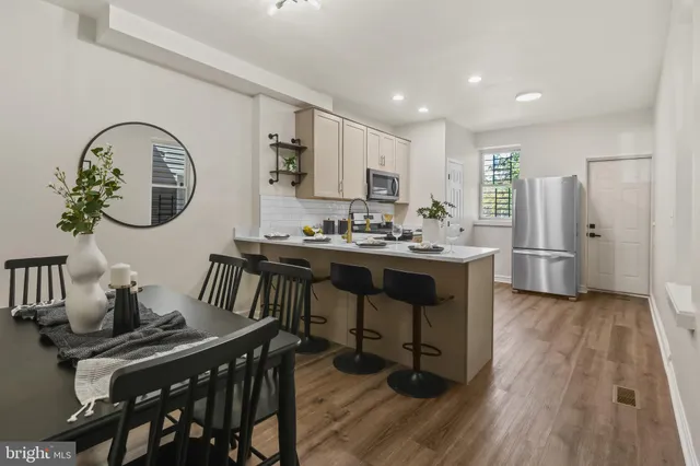 a view of a dining room with furniture and wooden floor