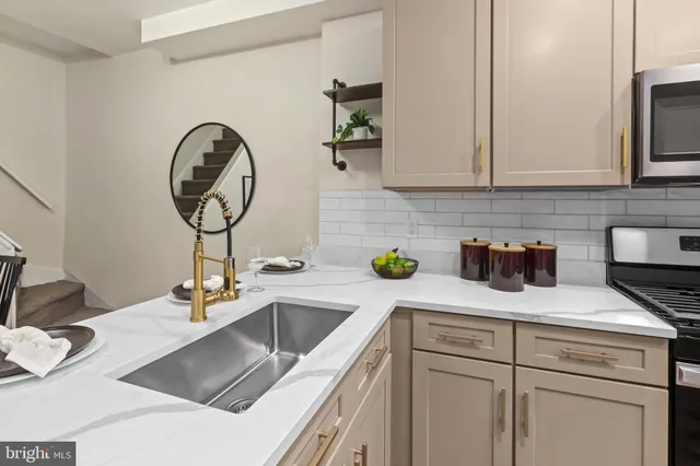 a kitchen with a sink and a stove top oven