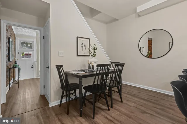 a view of a dining room with furniture and a mirror