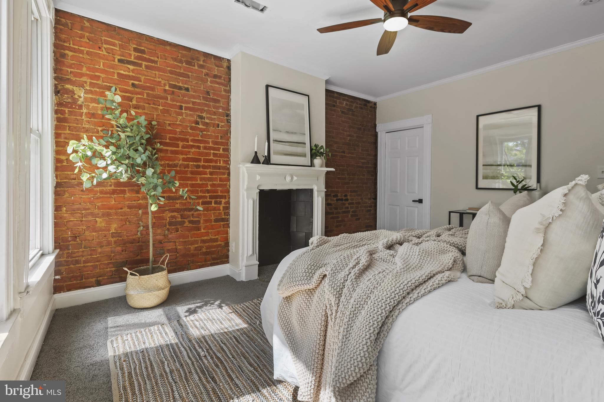 884 Washington Boulevard Baltimore, MD 21230 - Photo 21 of 35 a bedroom with a balcony a bed and a couch