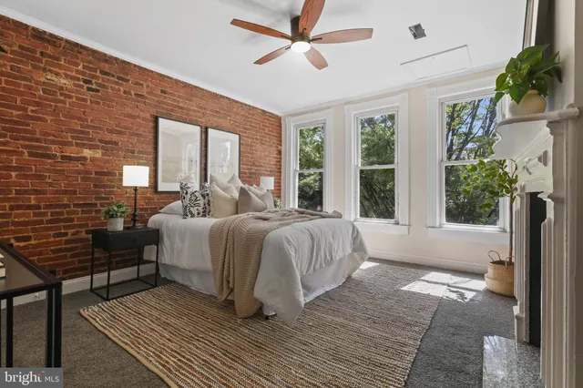 a spacious bedroom with a bed and a large window