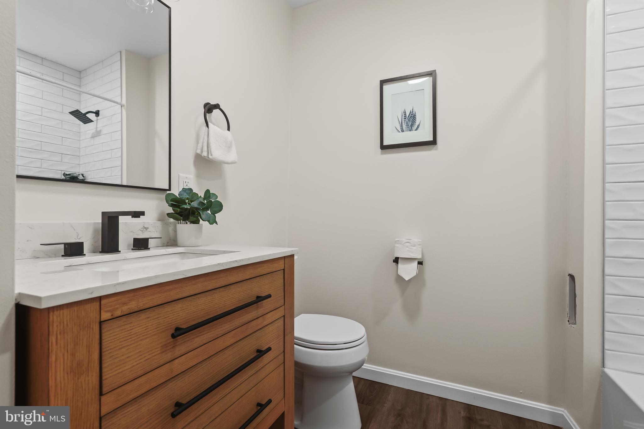 884 Washington Boulevard Baltimore, MD 21230 - Photo 24 of 35 a bathroom with a toilet a sink and mirror