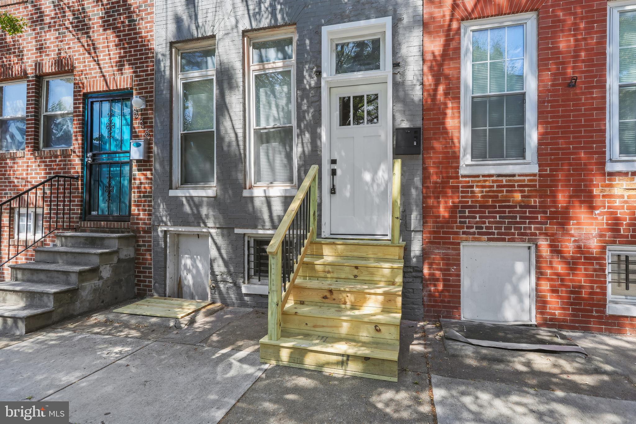 884 Washington Boulevard Baltimore, MD 21230 - Photo 3 of 35 a front view of a house with a yard