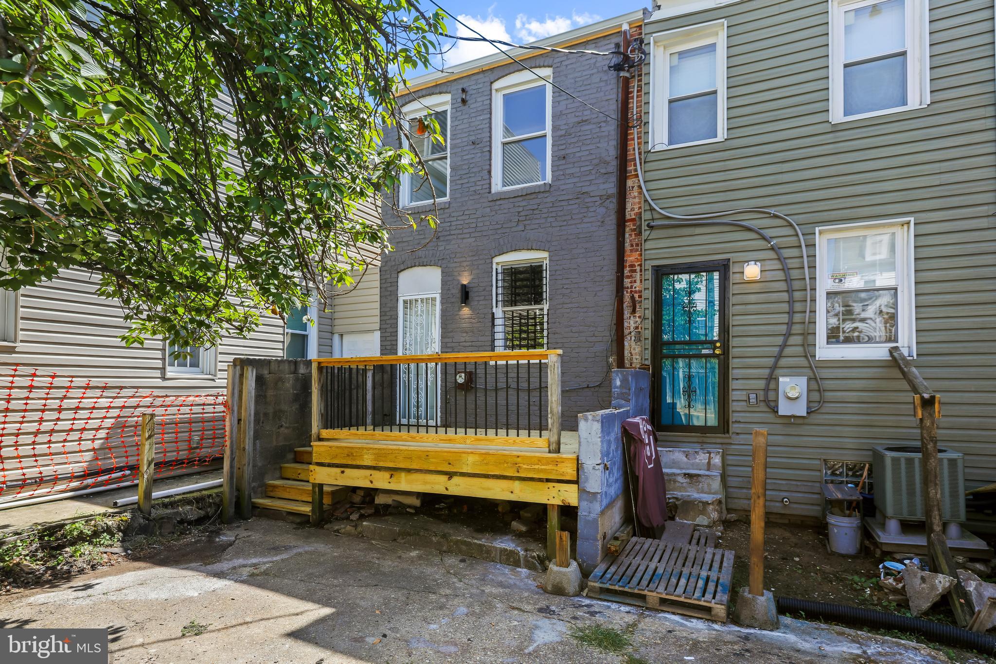 884 Washington Boulevard Baltimore, MD 21230 - Photo 35 of 35 a small garden is sitting in front of a house