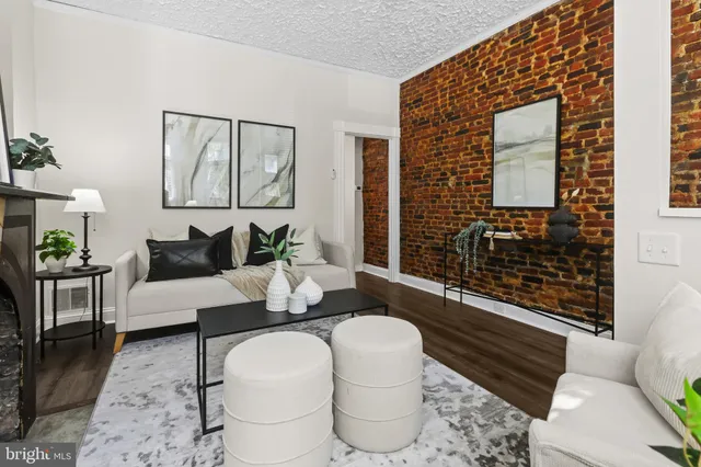 a living room with furniture and a potted plant