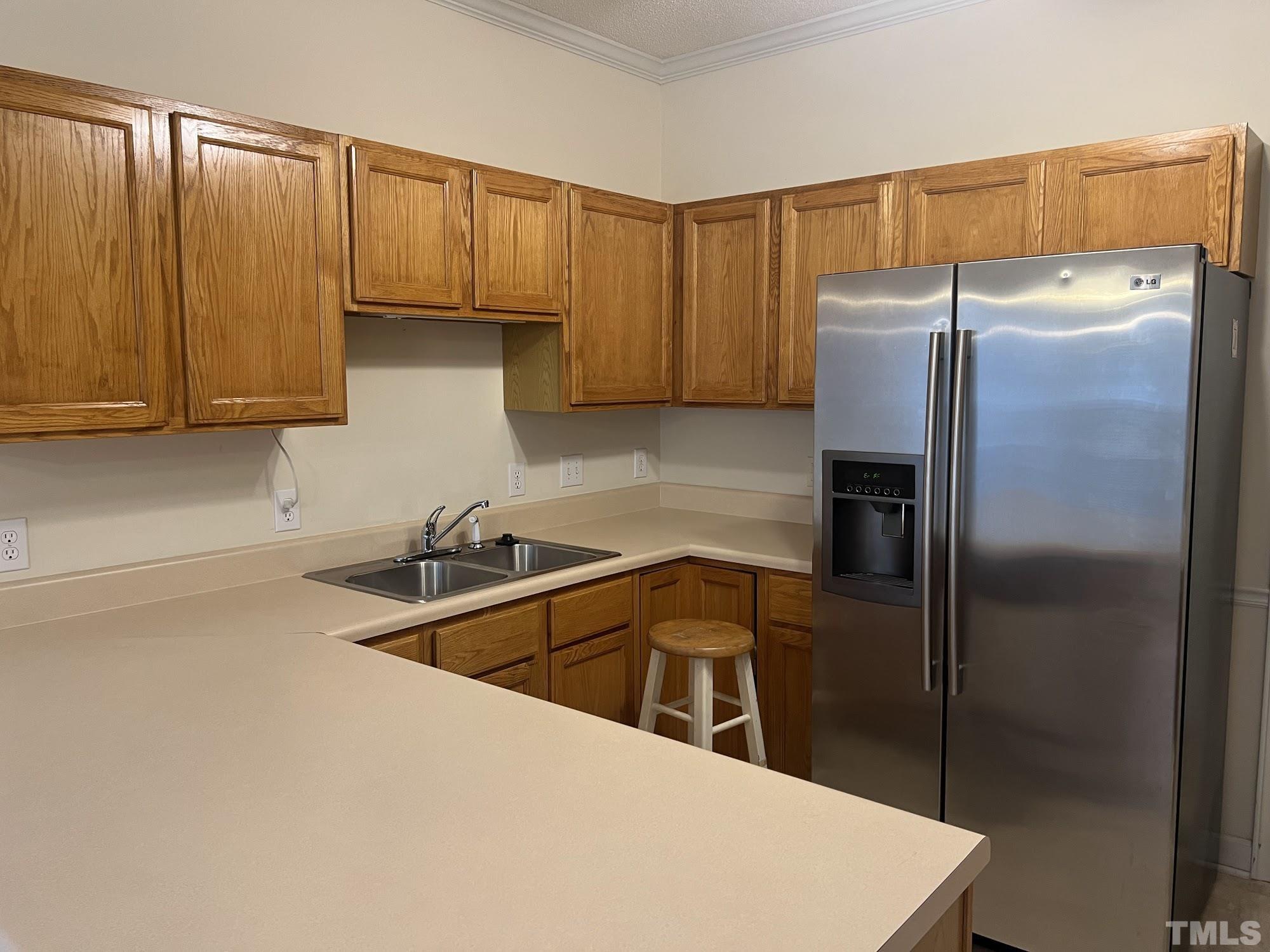 4216 Wolftrap Road Raleigh, NC 27616 - Photo 11 of 22 a kitchen with a refrigerator a sink and cabinets