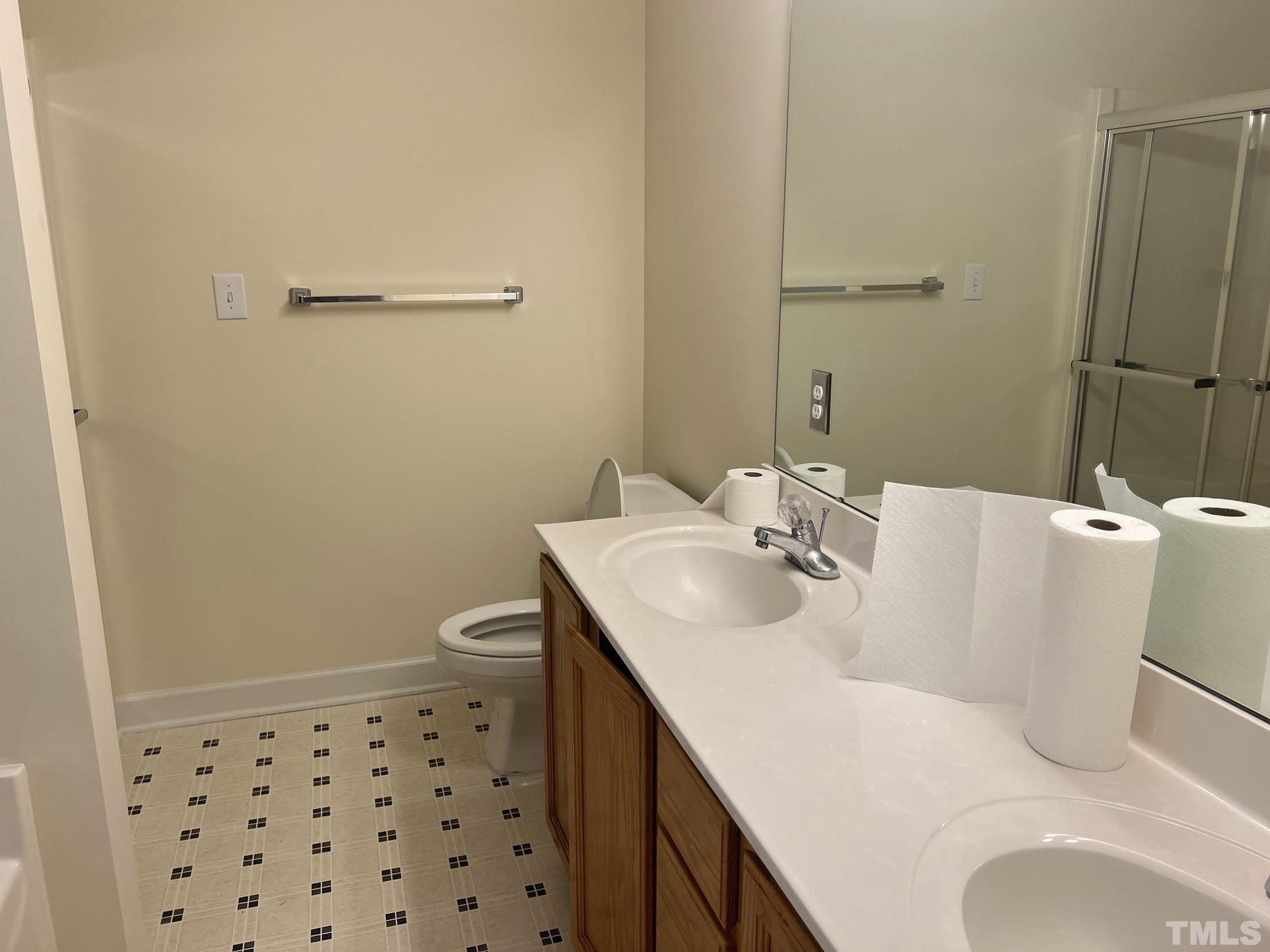 4216 Wolftrap Road Raleigh, NC 27616 - Photo 16 of 22 a bathroom with a sink a toilet and shower