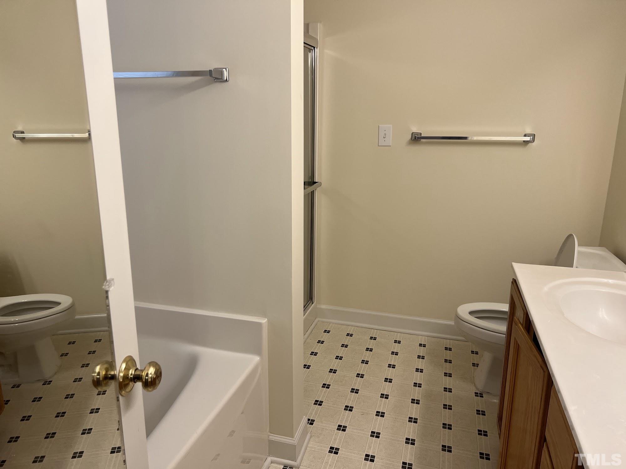 4216 Wolftrap Road Raleigh, NC 27616 - Photo 17 of 22 a bathroom with a sink a toilet and shower