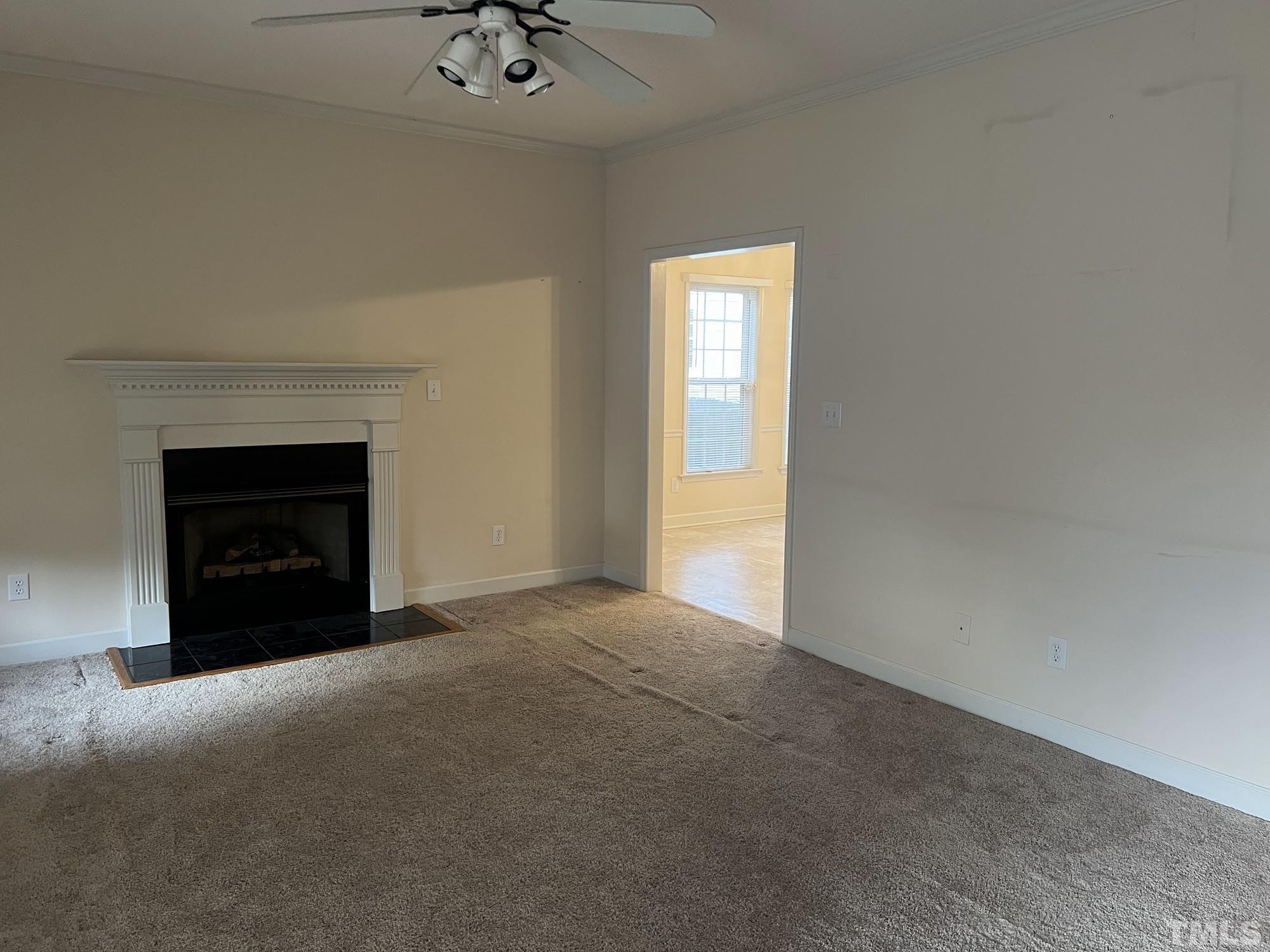 4216 Wolftrap Road Raleigh, NC 27616 - Photo 5 of 22 a view of an empty room with a fireplace