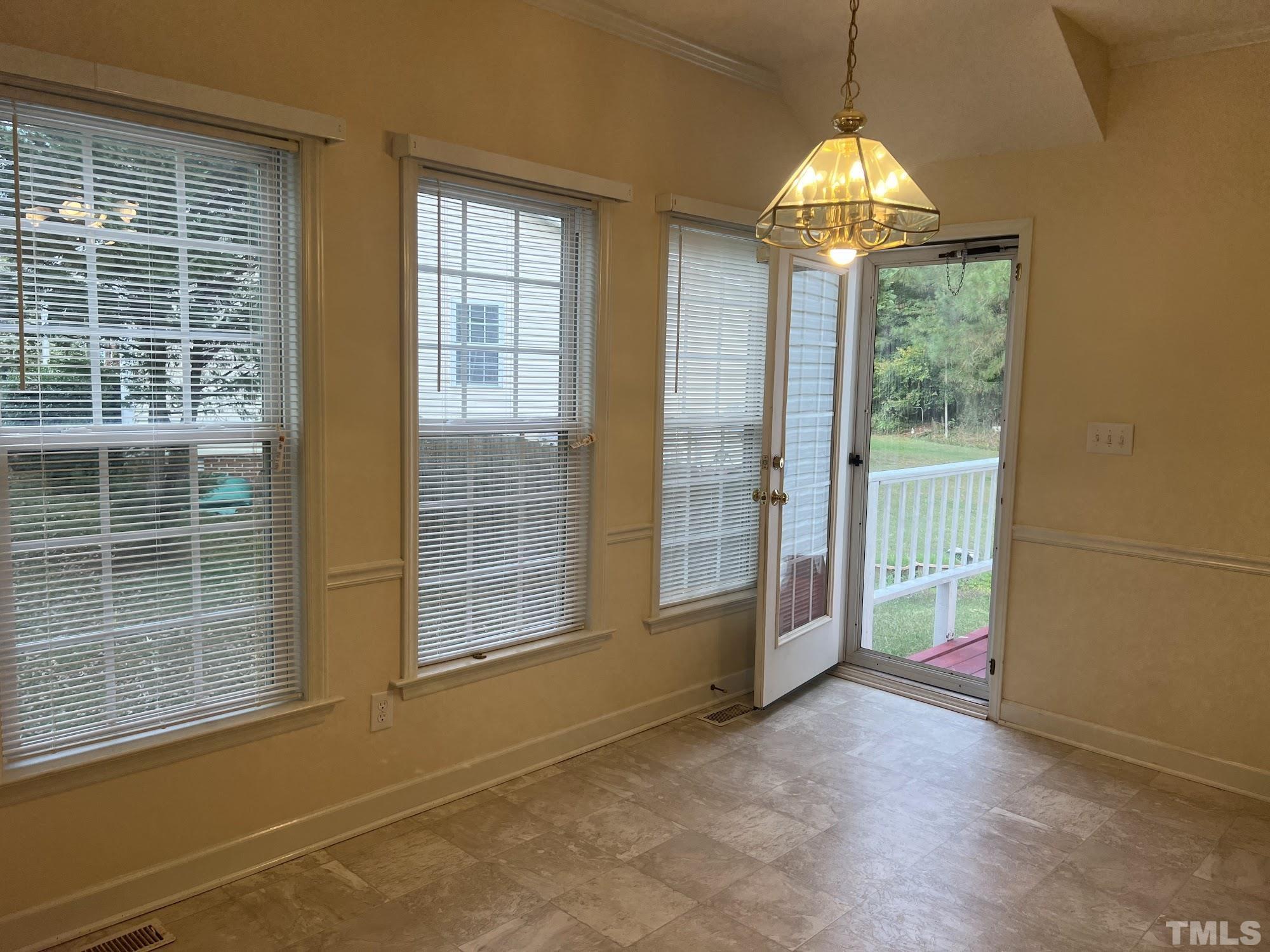 4216 Wolftrap Road Raleigh, NC 27616 - Photo 7 of 22 a view of empty room with windows