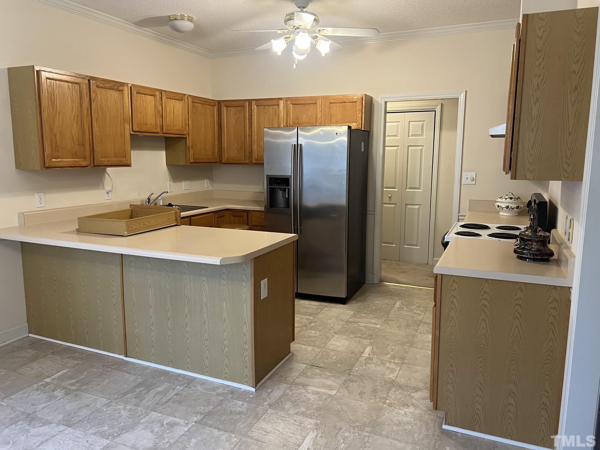 4216 Wolftrap Road Raleigh, NC 27616 - Photo 8 of 22 a kitchen with stainless steel appliances granite countertop a refrigerator and a sink