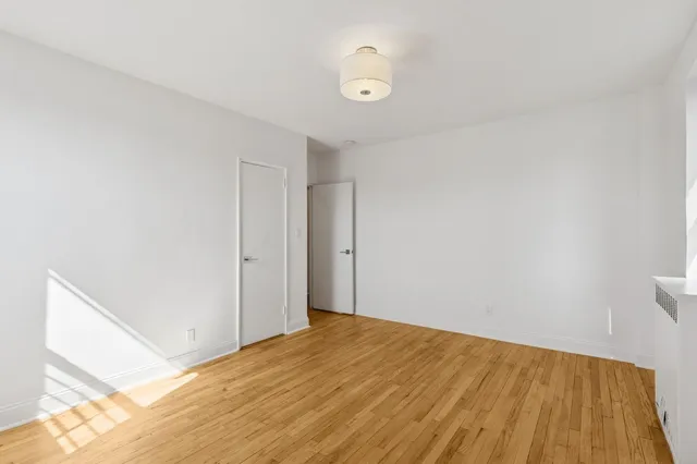 a view of hallway with wooden floor