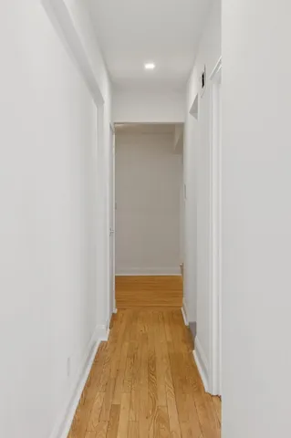 a picture of a bench in front of a wall