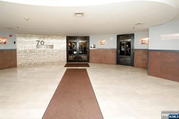 a view of a hallway with wooden floor and furniture