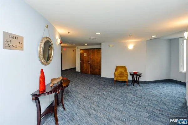 a view of a room with furniture and wooden floor