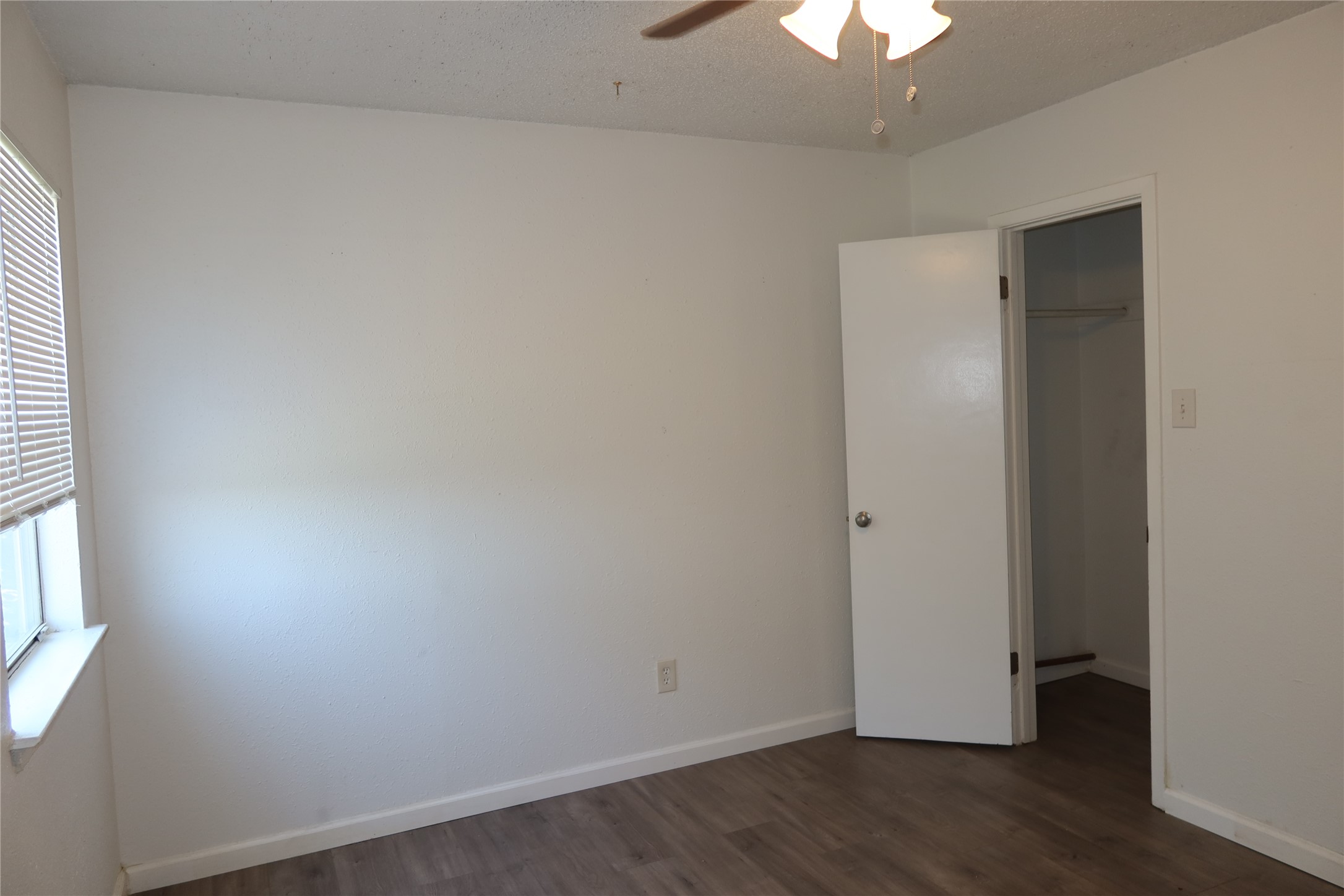 6914 Rifle Bend, Unit A Austin, TX 78736 - Photo 17 of 25 A minimalist bedroom displays clean lines with smooth walls and durable wood-look flooring.