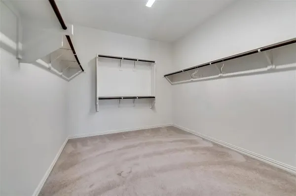 a view of a room with rack on the wall and a window