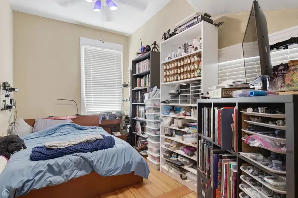 a bedroom with a bed and a book shelf