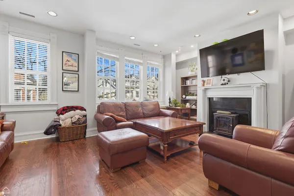a living room with fireplace furniture and a flat screen tv