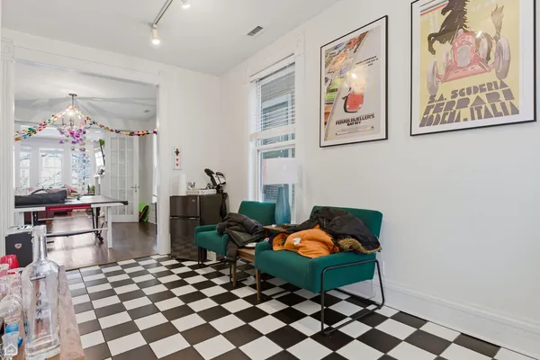 a living room with furniture and a chandelier