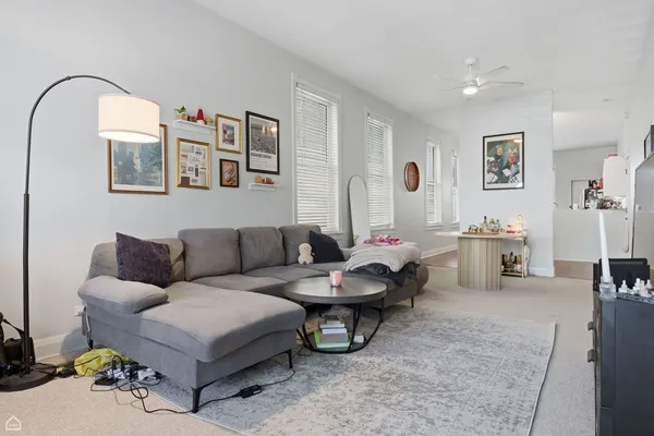a living room with furniture and a mirror