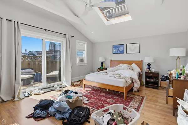a bedroom with bed and a window
