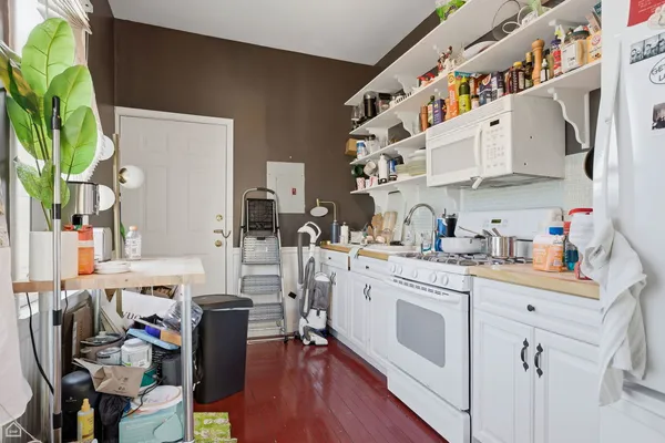 a kitchen with cabinets and wooden floor