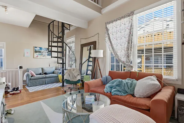a living room with furniture and a large window