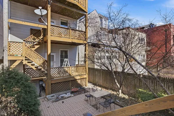 a table and chairs sitting in front of a building