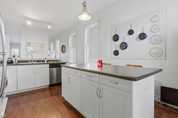 a kitchen with white cabinets and white appliances