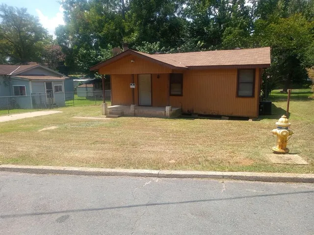 a house with trees in the background