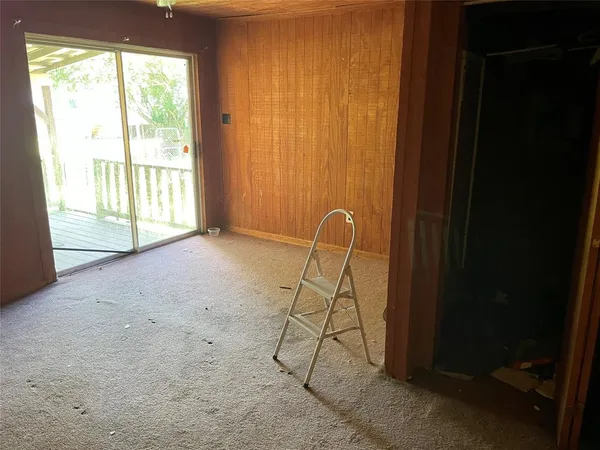 a view of a livingroom with a table and a chair