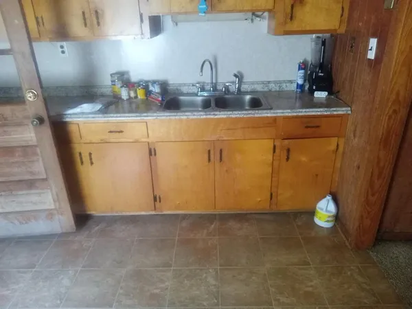 a kitchen with cabinets and appliances