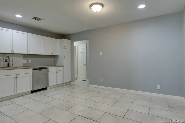 a kitchen with a sink and cabinets
