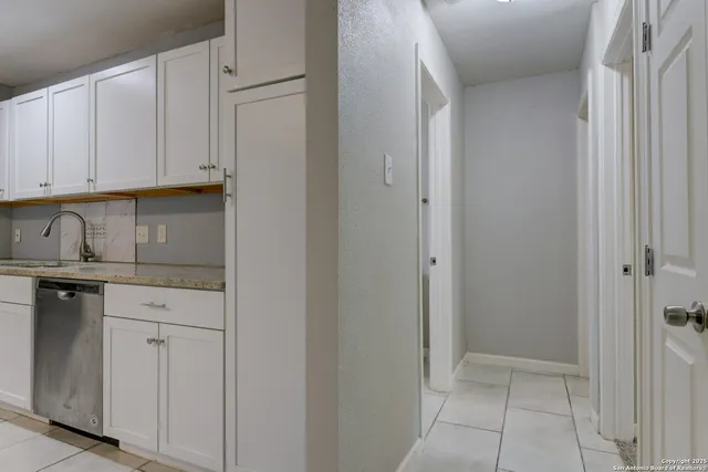 a kitchen with white cabinets