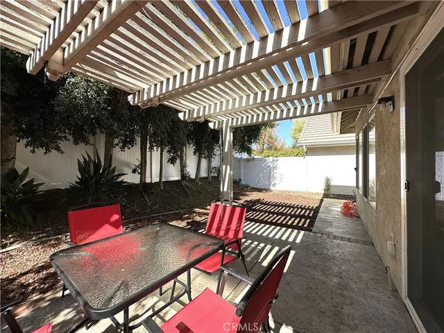 an outdoor sitting area with a table and chairs