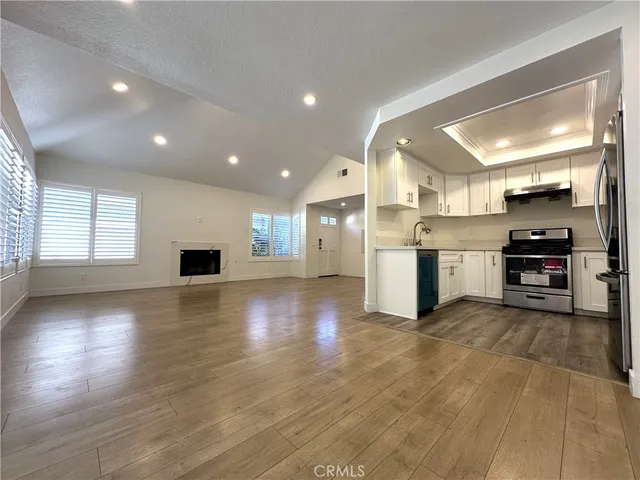 a view of a kitchen with a sink and a stove top oven