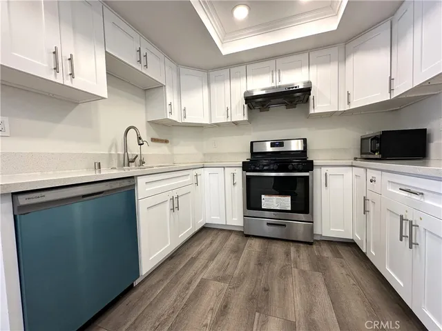 a kitchen with stainless steel appliances a stove sink and cabinets