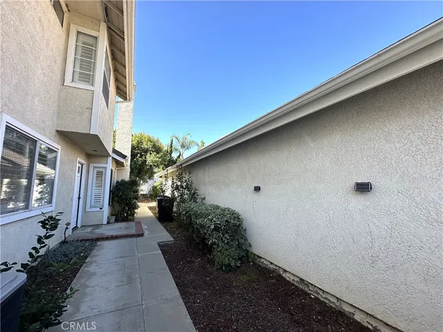a pathway of a house with a yard