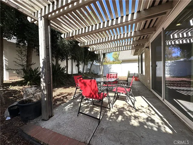 a view of a patio with table and chairs and potted plants