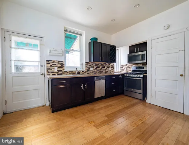 a kitchen with stainless steel appliances granite countertop a stove and a refrigerator