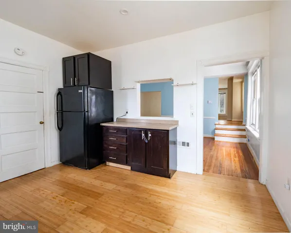 a kitchen with a refrigerator and a sink